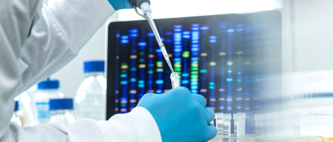 Scientist pipetting sample into a vial for DNA testing